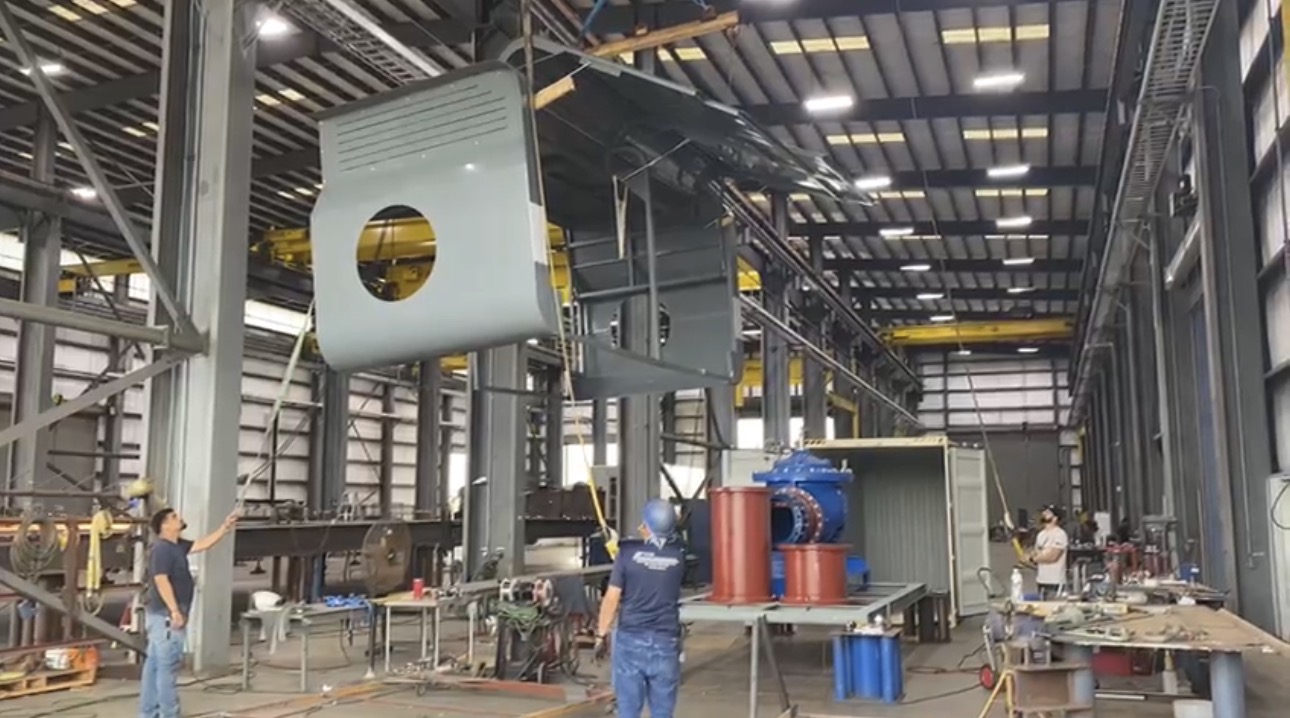 HydroXS enclosure being lifted into place during assembly